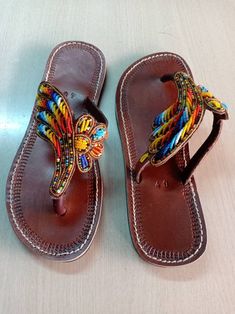 African beaded sandals, summer sandals, leather sandals, women sandals, gift for her, maasai beaded sandals. 100% handcrafted using maasai beads, Perfect christmas gift for her. All sizes are available as we custom make them. For perfect fitting kindly use the last image as a guide. Ships via dhl expressa Traditional Leather Flip Flops For Festivals, Traditional Leather Flip Flops For Summer, Leather Open Toe Flip Flops For Festivals, Beaded Leather Sandals For Festivals, Traditional Leather Sandals For Summer, Handmade Leather Flip Flops For Summer, Beaded Round Toe Sandals For Festivals, Beaded Sandals With Round Toe For Festivals, Traditional Leather Barefoot Sandals For Vacation