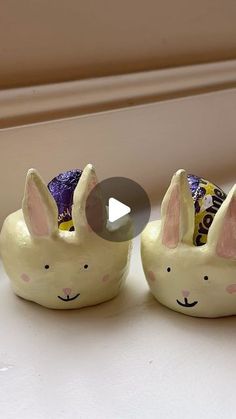 two ceramic rabbits sitting next to each other