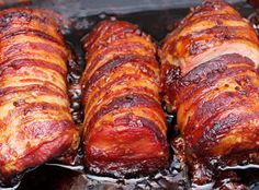 several pieces of bacon are cooking on a grill