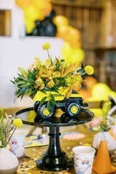 a table topped with a cake covered in yellow flowers