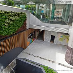 an aerial view of a building with plants growing on the walls