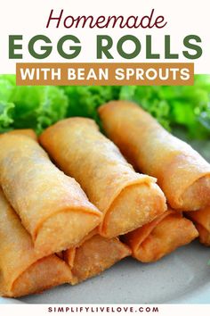 homemade egg rolls with bean sprouts on a plate next to lettuce