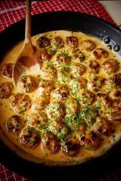 a skillet with some food in it and a wooden spoon