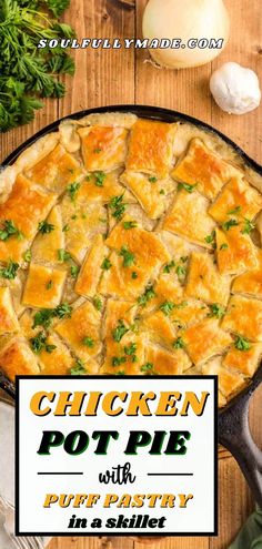 chicken pot pie with puff pastry in a skillet on a wooden table next to garlic and parsley