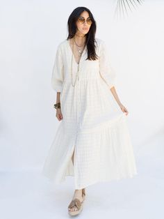 The Southern Star Maxi Shirtdress in Egret is a wardrobe essential for year-round styling. Crafted from shirred striped cotton, it can be worn as a duster layered over fall outfits or buttoned up as a breezy maxi dress or bathing suit cover up in summer. The hidden waist ties allow for versatility, offering both a relaxed or fitted look. Billowy Casual Maxi Dress For Daywear, Casual Billowy Maxi Dress For Daywear, Chic Cotton Maxi Dress For Daywear, Cotton Maxi Shirt Dress For Beach, Cotton Maxi Shirt Dress For The Beach, Billowy Maxi Dress For Dress Down Summer Days, Long Cotton Maxi Dress For Day Out, Chic Cotton Maxi Shirt Dress, Chic Billowy Maxi Dress For Day Out