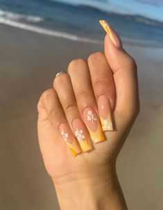 nail inspo, french tip, acrylic, gel x, gel nails, hibiscus flowers, nail art, orange, summer, tanning, uv, beach, sandy feet Yellow Hawaii Nails, Acrylic Nails Hawaiian Flowers, Hibiscus Flower Nails Long, Flower Nails Hawaii, Hawaii Aesthetic Nails, Yellow Nails Flower, Nail Inspo Summer Flower, Hibiscus Flower Nails Orange, Hawaii Flower Nails Hibiscus