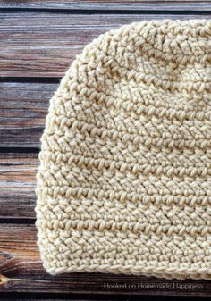 a crocheted hat sitting on top of a wooden table