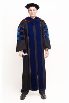 a man wearing a graduation gown and holding a remote control in his hand while standing against a white background