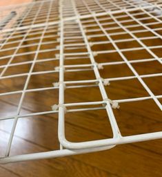 a close up view of a metal grate on a wooden floor with wood floors in the background