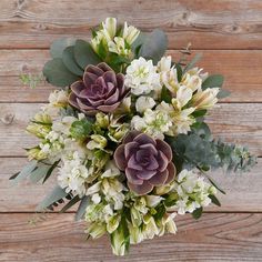 a bouquet of flowers on a wooden surface