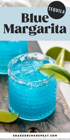 two blue margaritas sitting on top of a cutting board