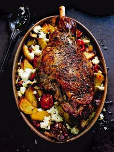 a roasting pan filled with meat and potatoes