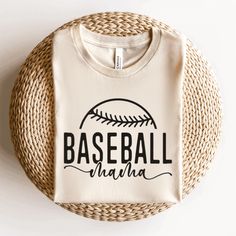 a baseball shirt sitting on top of a wicker basket next to a white wall