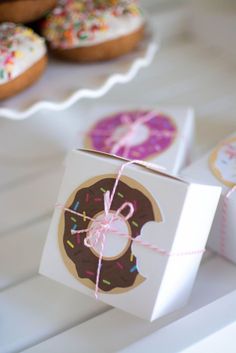 a box that has some doughnuts on it and tied with twine string