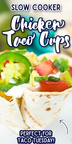 a close up of a burrito on a plate with the words slow cooker chicken taco cups