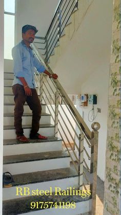 a man is standing on the stairs in his home