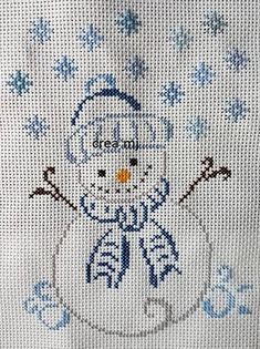 a cross stitch snowman is shown in blue and white