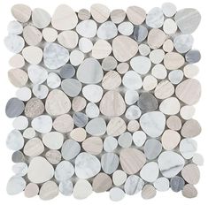 a white and grey mosaic tile with circles on the bottom, surrounded by smaller stones