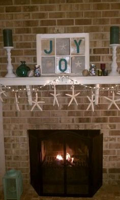 a fireplace decorated with starfish and candles