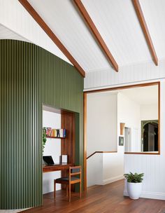 a room with green walls and wooden floors