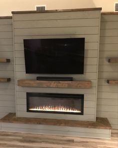 a flat screen tv mounted above a fireplace