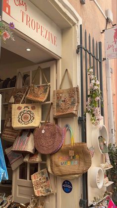 a store front with baskets and purses on display