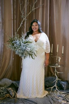 a woman in a white dress holding a bouquet of flowers