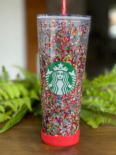 a starbucks cup with sprinkles and a straw