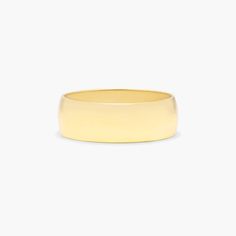 a yellow gold wedding ring on a white background