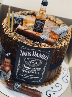 a birthday cake with liquor bottles and cigars on it