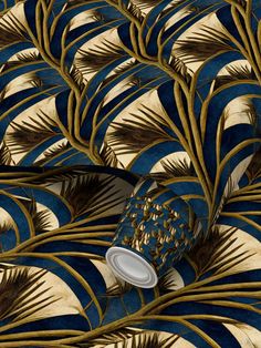 a blue and gold wallpaper with an abstract design in the middle, featuring feathers