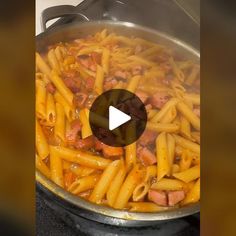 a pan filled with pasta and meat on top of a stove