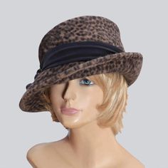 This beautiful ladies cloche is made from long velour fur felt, and hand draped over an antique hat block. Trimmed with a beautiful silk dupioni trim and vintage button  Please indicate your head size measurement when ordering (measure your head horizontally just above your eyebrows). When you receive your hat, there will be a small ribbon inside to fine-tune the fit, and a hat box for safe storage. Note: Colors will vary depending on your monitor and there will also be some variations due to dye lots. I personally create each hat one at a time, and no two are ever exactly the same.  My hats are 100% handmade for you, using traditional Millinery techniques and the highest quality fabrics and details.  I frequently trim  my hats with one-of-a-kind details, i.e. vintage buttons, antique broo Antique Hat, Hat Blocks, Silk Dupioni, Antique Hats, Elegant Hats, Fancy Hats, Millinery Hats, Antique Brooches, Hat Box