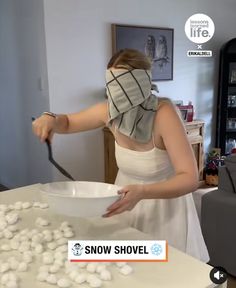 a woman in a white dress is cutting snowballs