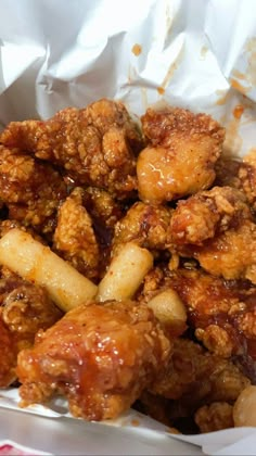 fried chicken and potatoes in a paper container