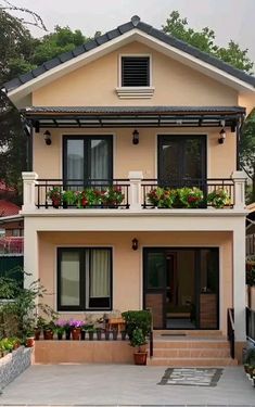 a house with flowers on the balconies