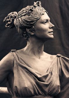 a statue of a woman with braids on her head