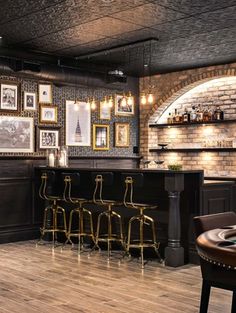 a bar with several stools and pictures on the wall