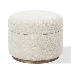 a round ottoman with a wooden base and white upholstered fabric