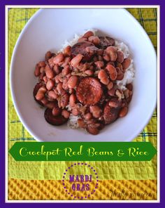 a white bowl filled with red beans and rice on top of a yellow table cloth