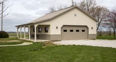 a two car garage sitting on top of a lush green field