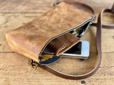 After a request from a lady in Saskatchewan, we now have a zippered leather fanny pack. It is perfect for holding your large phone, keys and credit cards. Closed with a metal zipper and finished with a brown leather half inch adjustable strap, it makes a great addition to our small bag collection.  Approximate dimensions: 9 inches wide  Just over 5 inches in height 1 inch in depth The fanny pack is made with Crazy Horse Water Buffalo leather - our best leather! As each fanny pack is handcrafted Leather Phone Bag With Zipper Pocket For On-the-go, Leather Belt Bag With Zipper Pouch For Everyday, Everyday Leather Phone Bag With Zipper, Leather Phone Bag With Zipper Closure For Everyday Use, Leather Phone Bag With Zipper For Everyday Use, Everyday Leather Phone Bag With Zipper Pocket, Crossbody Belt Bag With Zipper Pocket, Everyday Carry Crossbody Belt Bag With Zipper Pocket, Buffalo Bag