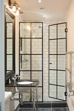 a bathroom with a sink, mirror and shower stall in the middle of the room