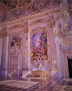 an ornate room with chandeliers and paintings on the walls