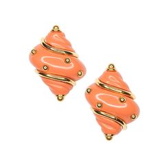 pair of orange earrings with gold accents