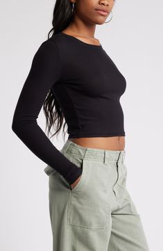 Svelte and stretchy, this finely ribbed crop top is the perfect match for high-rise styles and is polished off by a graceful scoop neckline. 17 1/2" length (size Medium)   Scoop neck   Long sleeves   97% Lenzing™ EcoVero™ viscose, 3% spandex   Lenzing EcoVero viscose is a sustainably produced fiber using pulp made from renewable wood sources and certified with the EU Ecolabel for high environmental standards, including lower emissions and water usage than generic viscose   Machine wash, dry flat Sleek Cropped Top, Chic Fitted Crop Top With Cropped Hem, Versatile High Stretch Crew Neck Crop Top, Versatile High-stretch Crew Neck Crop Top, Fitted Crew Neck Crop Top For Fall, Fall Fitted Crew Neck Crop Top, Scoop Neck Crop Top For Night Out In Spring, Scoop Neck Crop Top For Spring Night Out, Spring Night Out Scoop Neck Crop Top