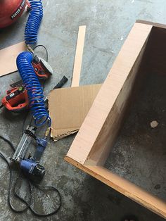 the tools are laying on the floor next to the box