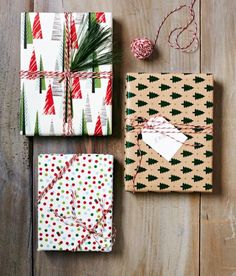 presents wrapped in wrapping paper and tied with twine on wooden floor next to christmas tree ornament