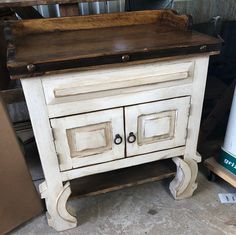 an old wooden cabinet with two doors and drawers