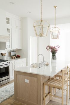 a kitchen with white cabinets and an island